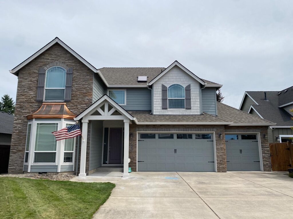 Two-story home with freshly painted gray siding and white trim