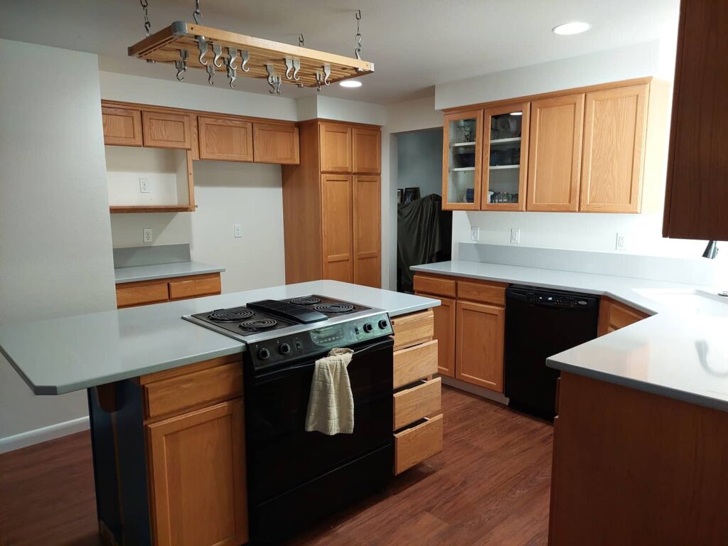 Kitchen with wood cabinets and white countertops