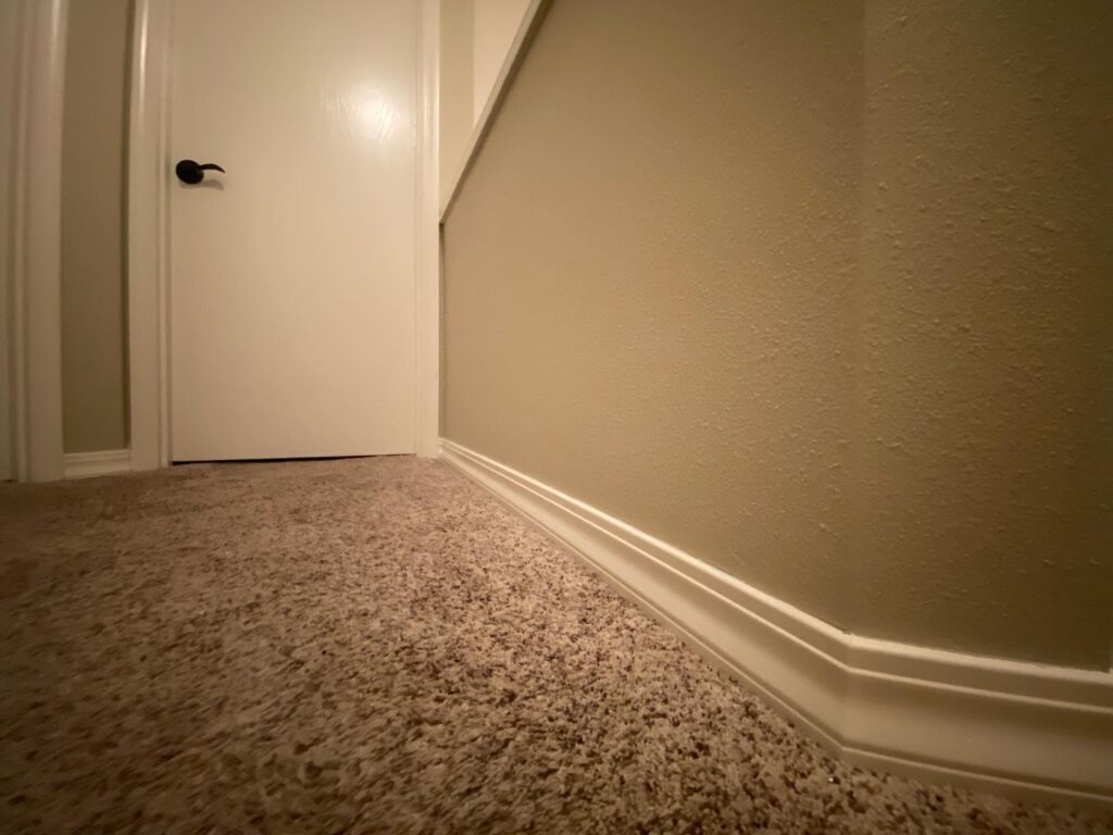 Hallway walls and baseboard trim after interior painting
